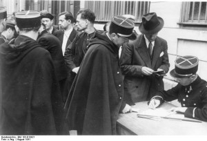 Gendarmes handle identity check and registration of Jews, France 1941 [Attr: Bundesarchiv Bild 183-B10921, wikimedia commons]