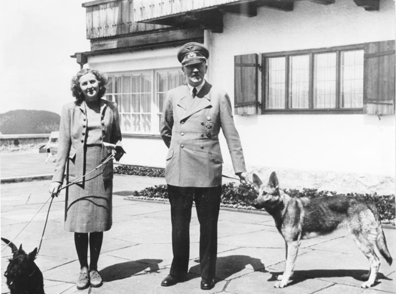 Eva Braun with either Negus or Stasi, and Adolf Hitler with Blondi (if 1942) or Blonda (if 1940), taken at the Berghof [Attr: Bundesarchiv, B 145 Bild-F051673-0059 / CC-BY-SA, wikimedia commons]
