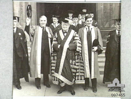 Australian Prime Minister Robert Menzies (waving his cap) and newly appointed United States Ambassador to Britain John Winant receive honorary degrees from Bristol University, where Winston Churchill is Chancellor, Bristol, 1941 [Public domain, Australian War Memorial]