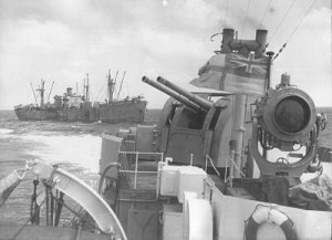 A Liberty Ship can be seen in the background, sailing under the protection of escort vessel HMS Badsworth [Public domain/wiki]