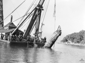 Japanese midget submarine M-21 being raised from Sydney Harbour, 10 June 1942 [Public domain, wiki]