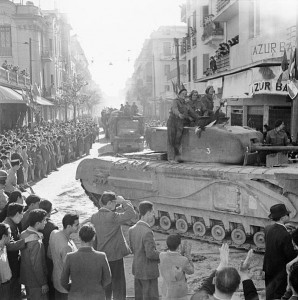 British Churchill tank and other vehicles parade through Tunis, 8 May 1943 [Public domain, IWM]