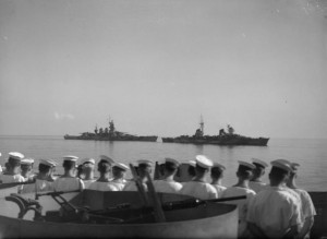 An Italian cruiser and battleship steam slowly past Royal Navy escorting ships en route to Malta to surrender, 10 September 1943 [Public domain]