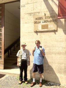 A sunny day in Rome: Jeff Williams and WWII aficionado, Steve McCarthy, stand outside the former Gestapo HQ, now the Historical Museum of the Liberation [photograph by Edith-Mary Smith]