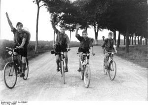 Hitler Youth bicyclists give the Hitler salute, 1932 [Bundesarchiv, B 145 Bild-P049482/ CC-BY-SA 3.0]
