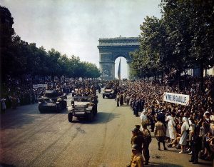 Crowds line the Champs Elysees to watch the Free French tanks and halftracks of General Leclerc's 2nd Armoured Division, 25 August 1944 [Public domain]