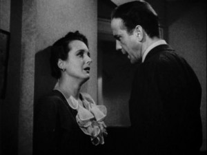 Crusty private eye Sam Spade (Humphrey Bogart) confronts femme fatale Brigid O'Shaughnessy (Mary Astor) in the movie 'The Maltese Falcon' [Public domain, wiki]