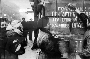 The siege is over: Citizens of Leningrad paint out a sign warning of the danger of enemy artillery; Leningrad 1944 [Public domain]